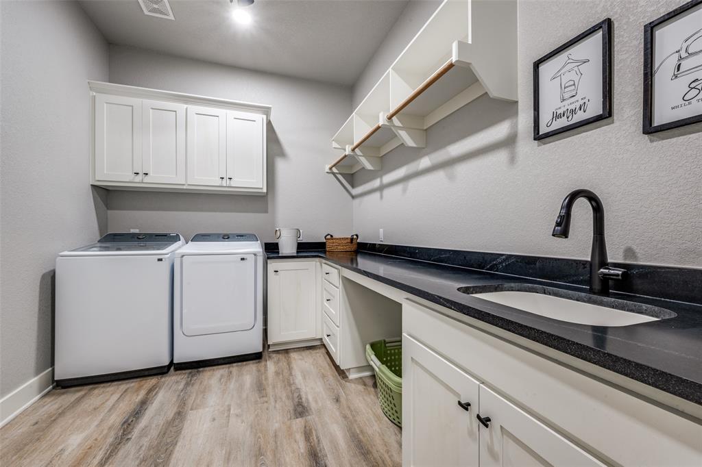 123 Proctor Lane Decatur, TX 76234 - Photo 21 of 25 a kitchen with white cabinets stainless steel appliances and sink