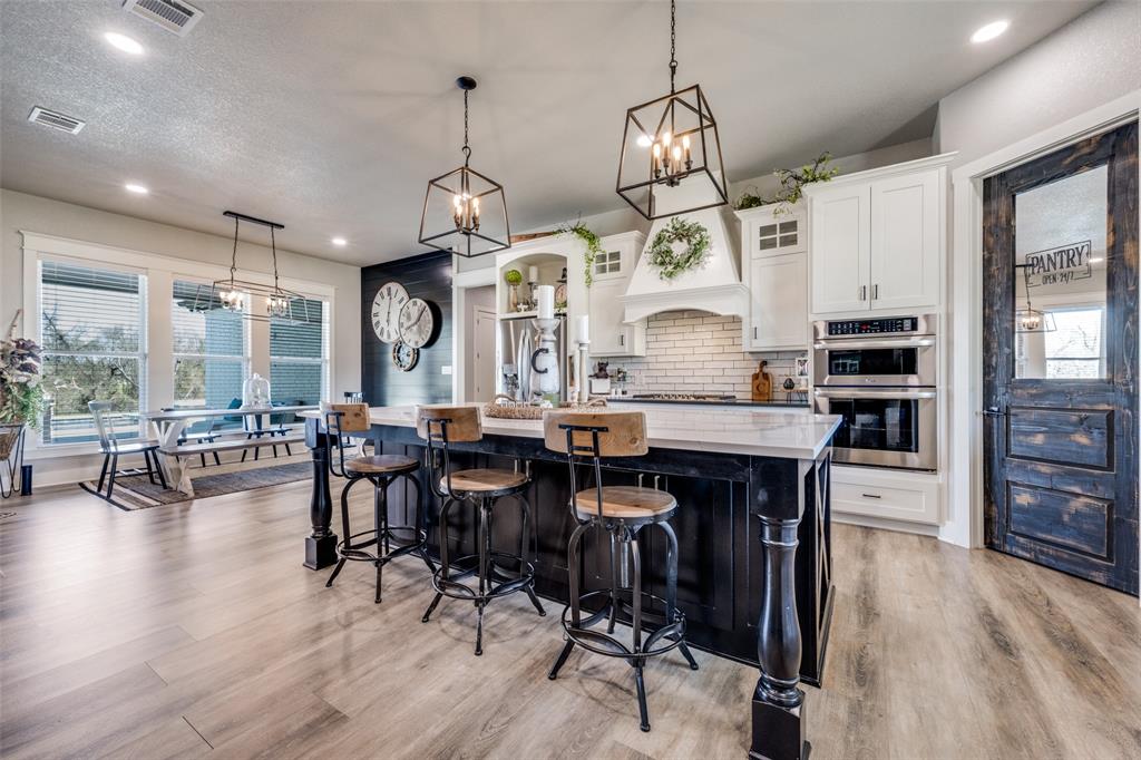 123 Proctor Lane Decatur, TX 76234 - Photo 8 of 25 a large kitchen with a table and chairs