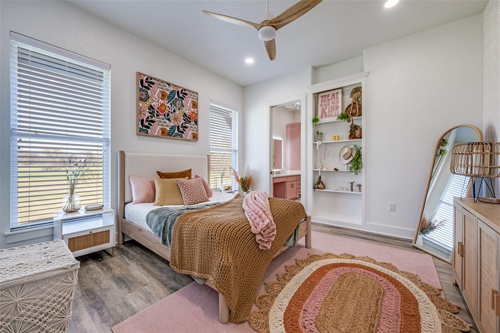 123 Proctor Lane Decatur, TX 76234 - Photo 10 of 25 a spacious bedroom with a bed a couch and a window