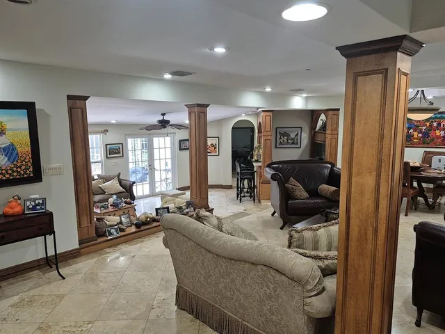 a kitchen with stainless steel appliances kitchen island granite countertop a sink stove and refrigerator