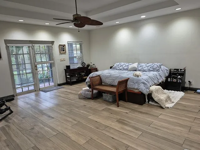 a living room with furniture and a floor to ceiling window