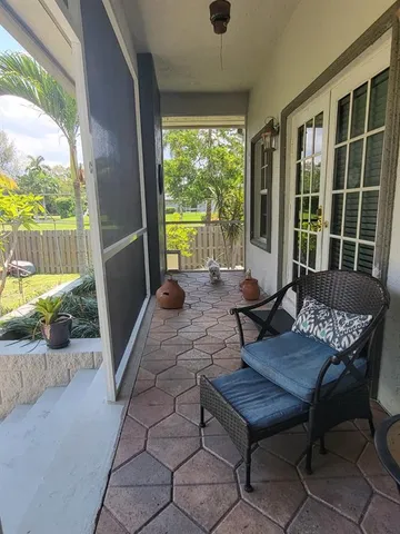 a view of a house with backyard and a tree