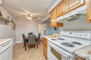 a kitchen with a stove a table and chairs