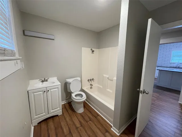 a view of hallway with wooden floor