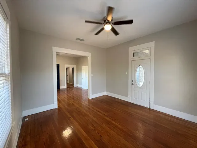 wooden floor in an empty room with a window
