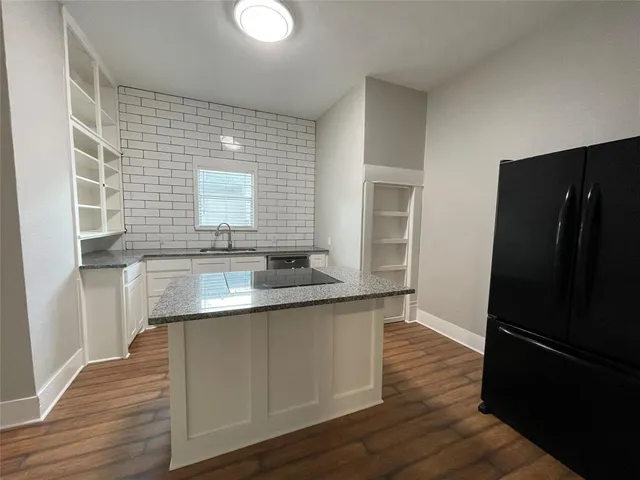 a kitchen with stainless steel appliances granite countertop a sink and wooden cabinets