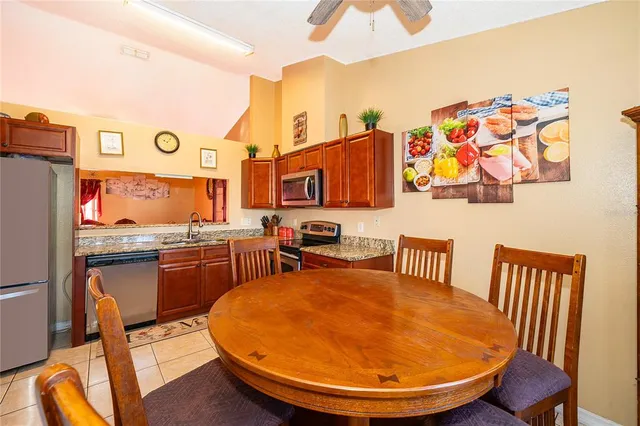a view of a kitchen with granite countertop a sink and dishwasher a wooden floor