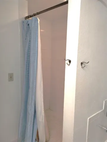 a bathroom with a shower and a tub