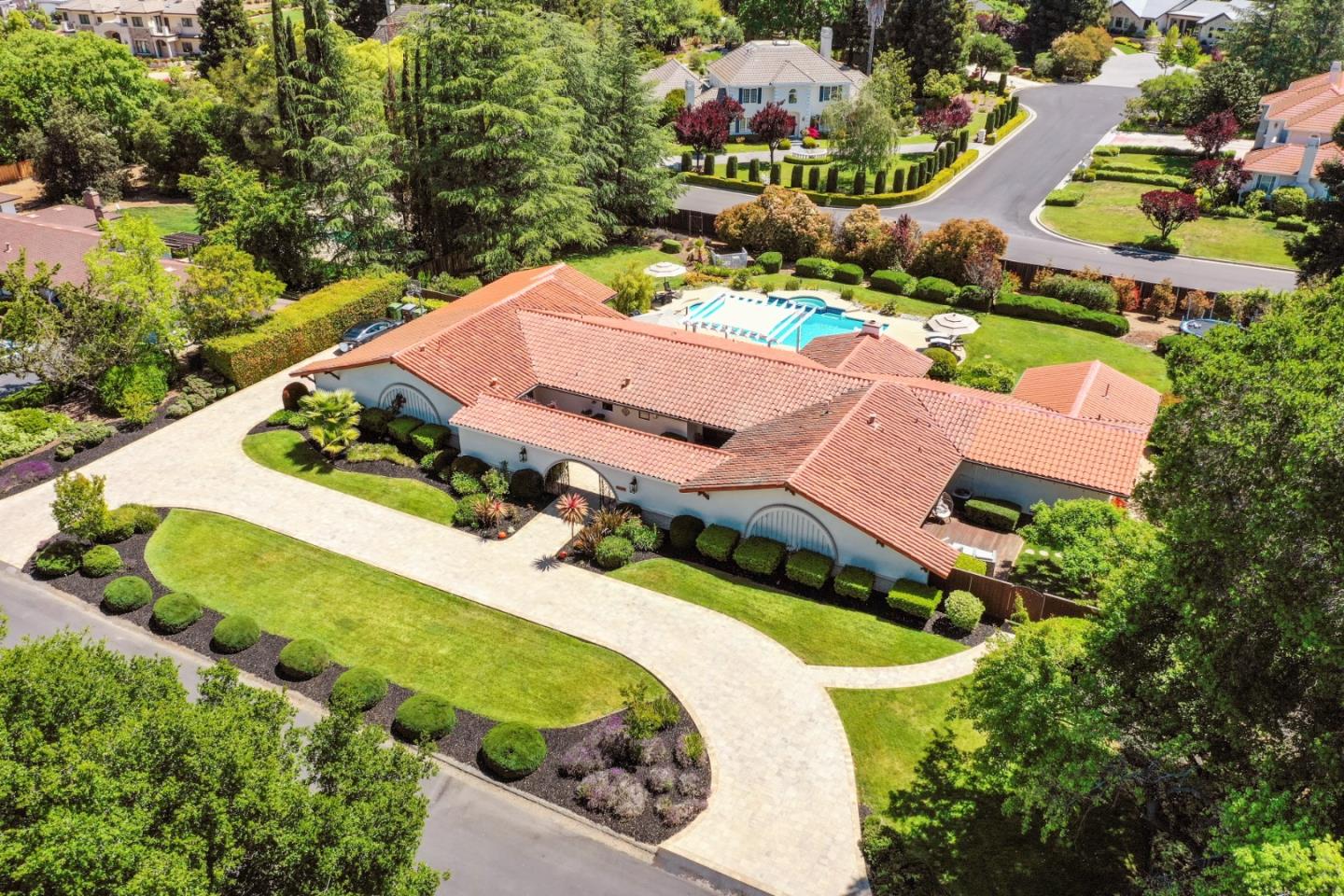 an aerial view of a house with a garden and swimming pool