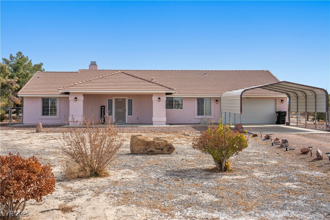 3581 Ranger Way Pahrump, NV 89048 - Photo 43 of 57 Ranch-style home with a tiled roof, a chimney, an attached garage, and stucco siding