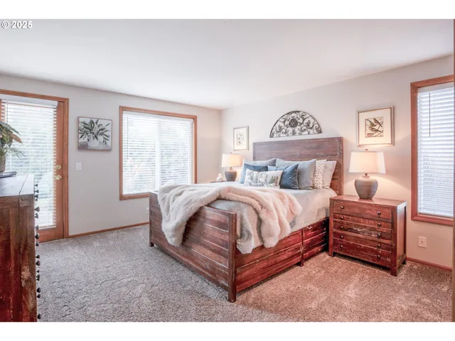 a spacious bedroom with a bed and window