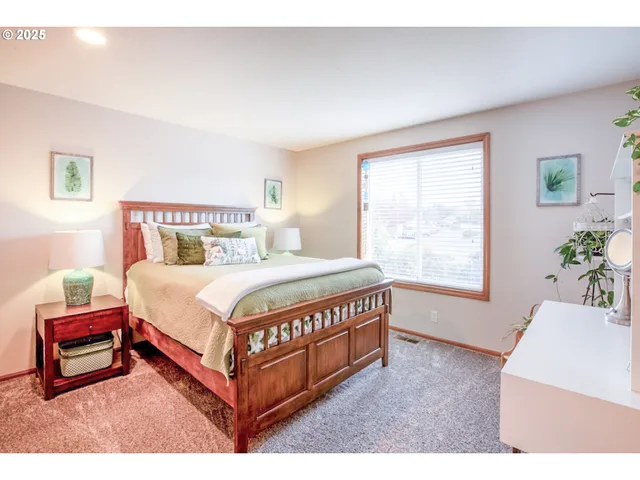 a bed sitting in a bedroom next to a window