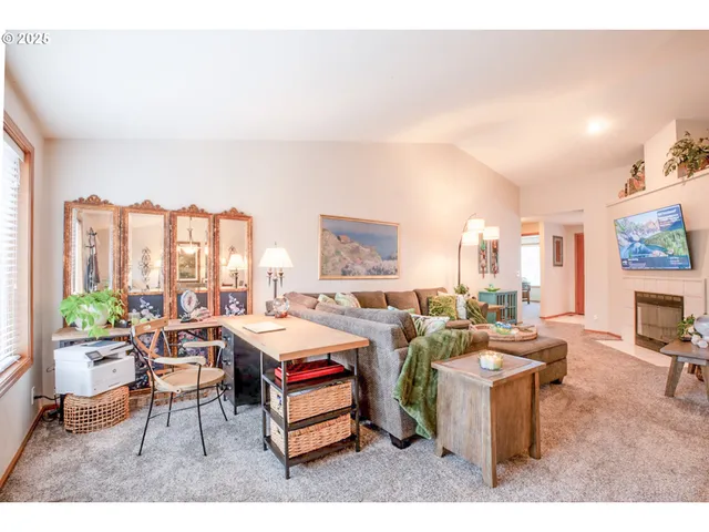 a room with furniture a rug and a large window