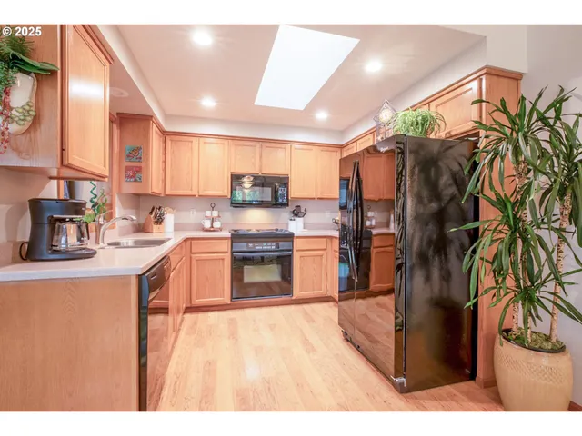a kitchen with stainless steel appliances a refrigerator and a stove top oven