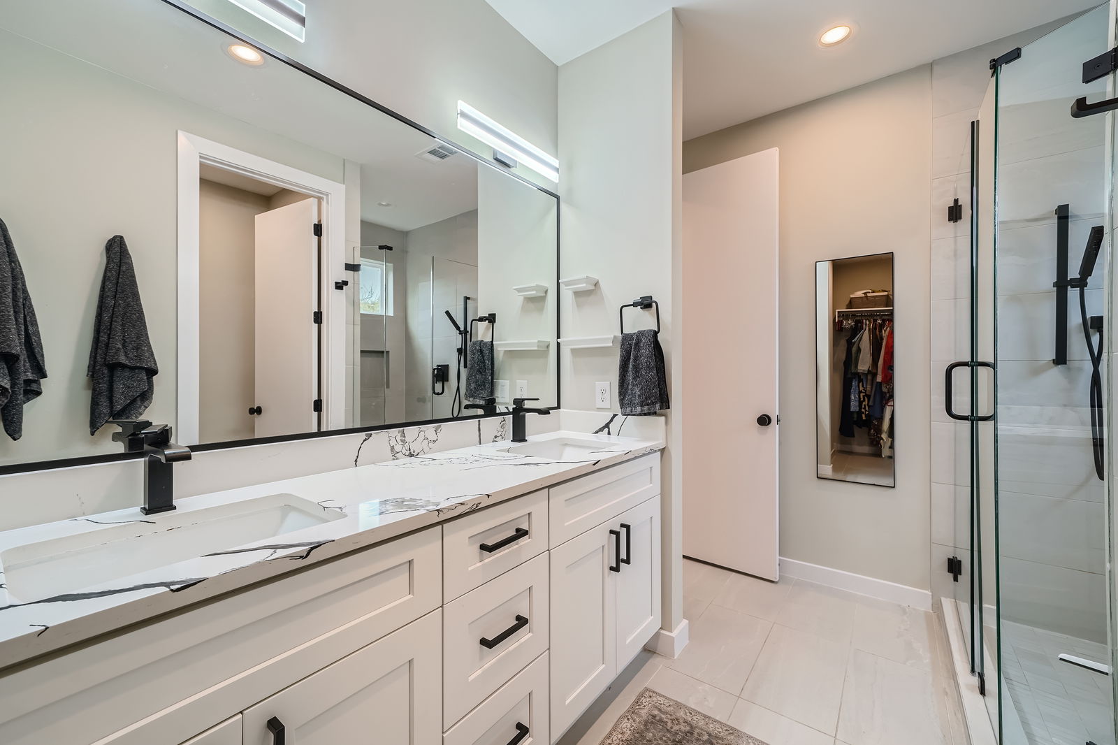 7507 Bethune Avenue, Unit B Austin, TX 78752 - Photo 12 of 23 Full bathroom featuring a walk in shower, double vanity, and a spacious closet.