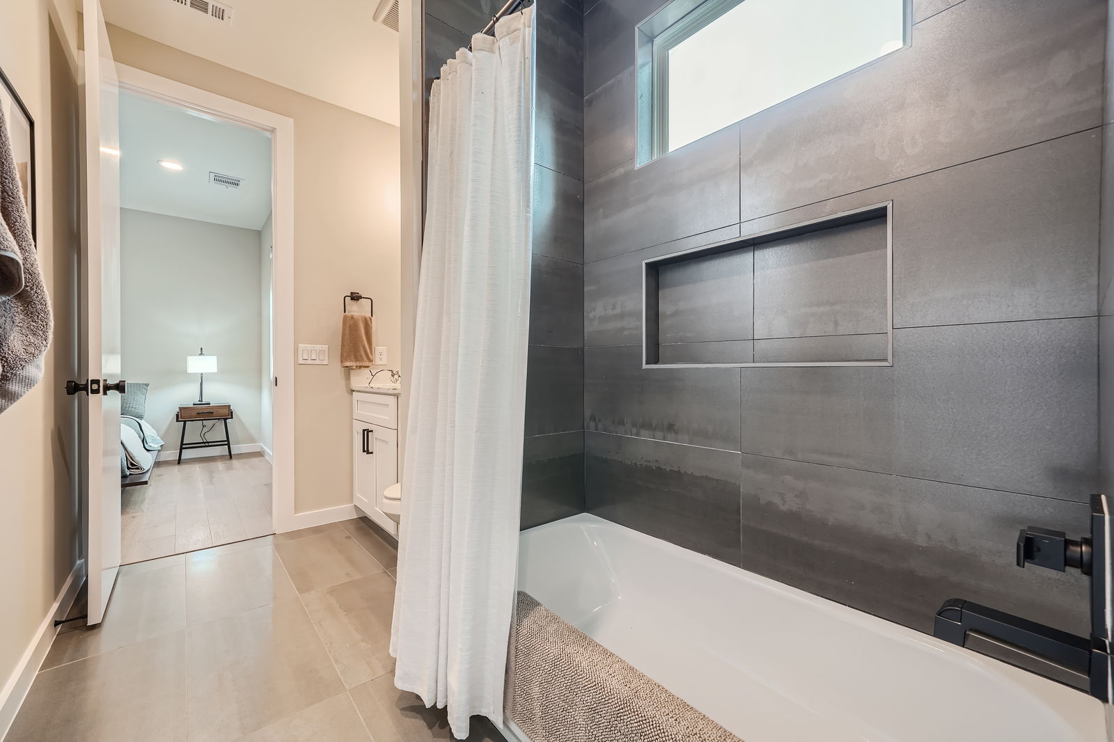 7507 Bethune Avenue, Unit B Austin, TX 78752 - Photo 16 of 23 Guest bathroom with tub and tasteful tile.
