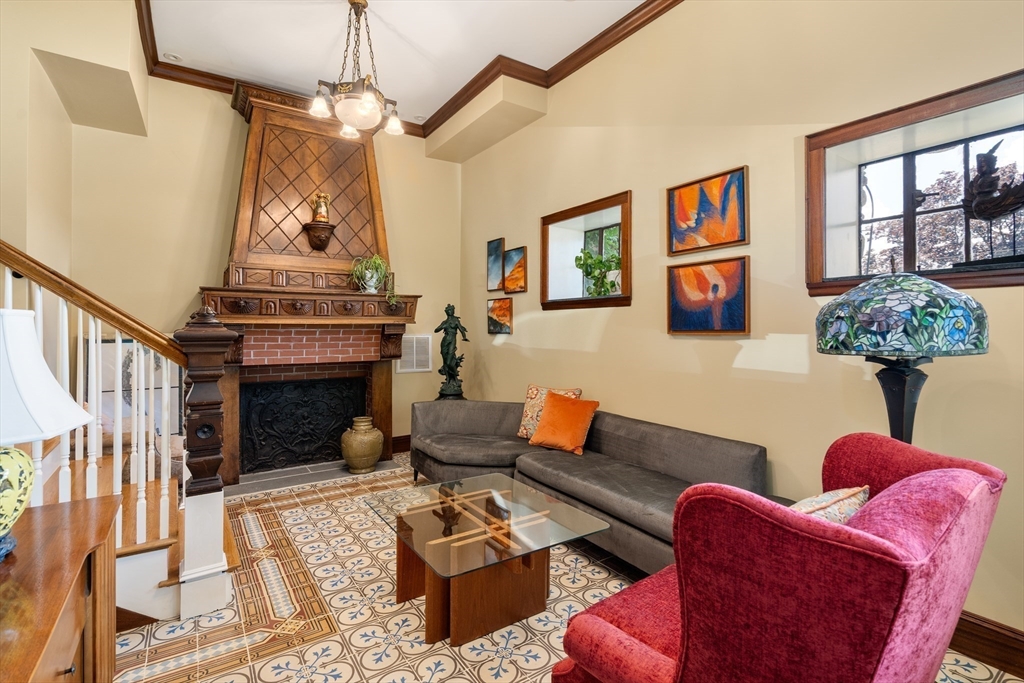 63 Crabtree Road Quincy, MA 02171 - Photo 11 of 41 a living room with furniture a chandelier and a fireplace