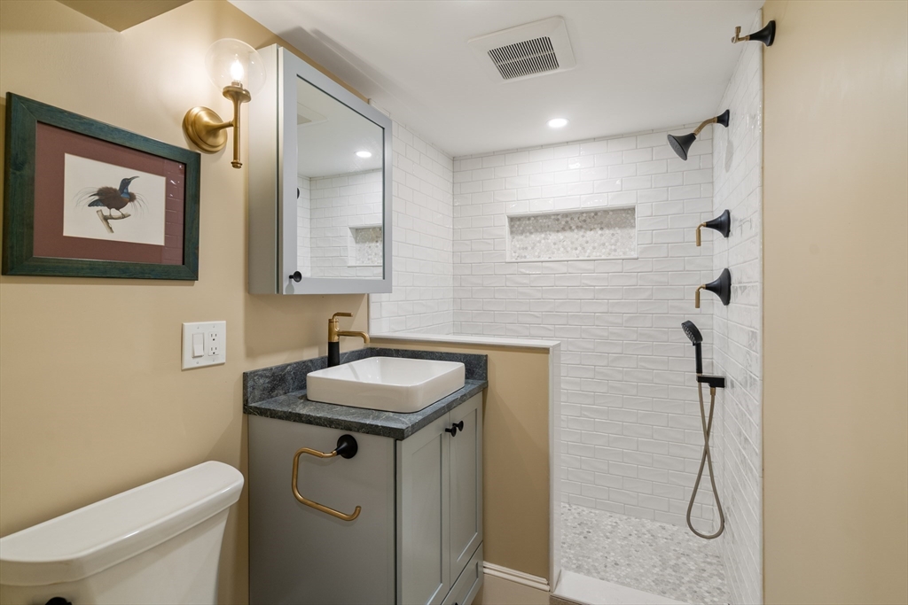 63 Crabtree Road Quincy, MA 02171 - Photo 26 of 41 a bathroom with a sink toilet and a mirror