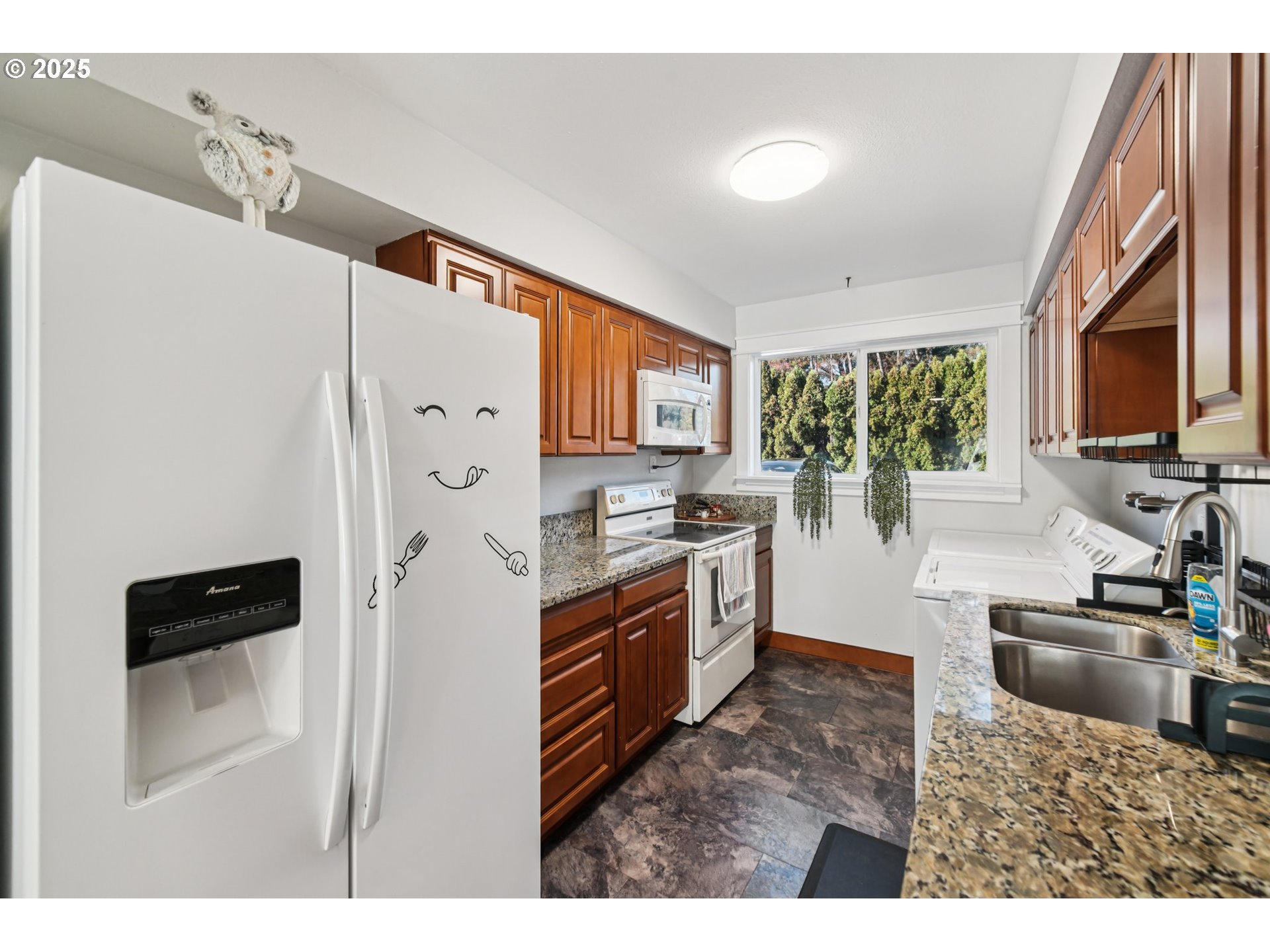 1302 Northeast Hogan Drive, Unit 169 Gresham, OR 97030 - Photo 14 of 46 a kitchen with stainless steel appliances granite countertop a refrigerator a stove a sink and a microwave