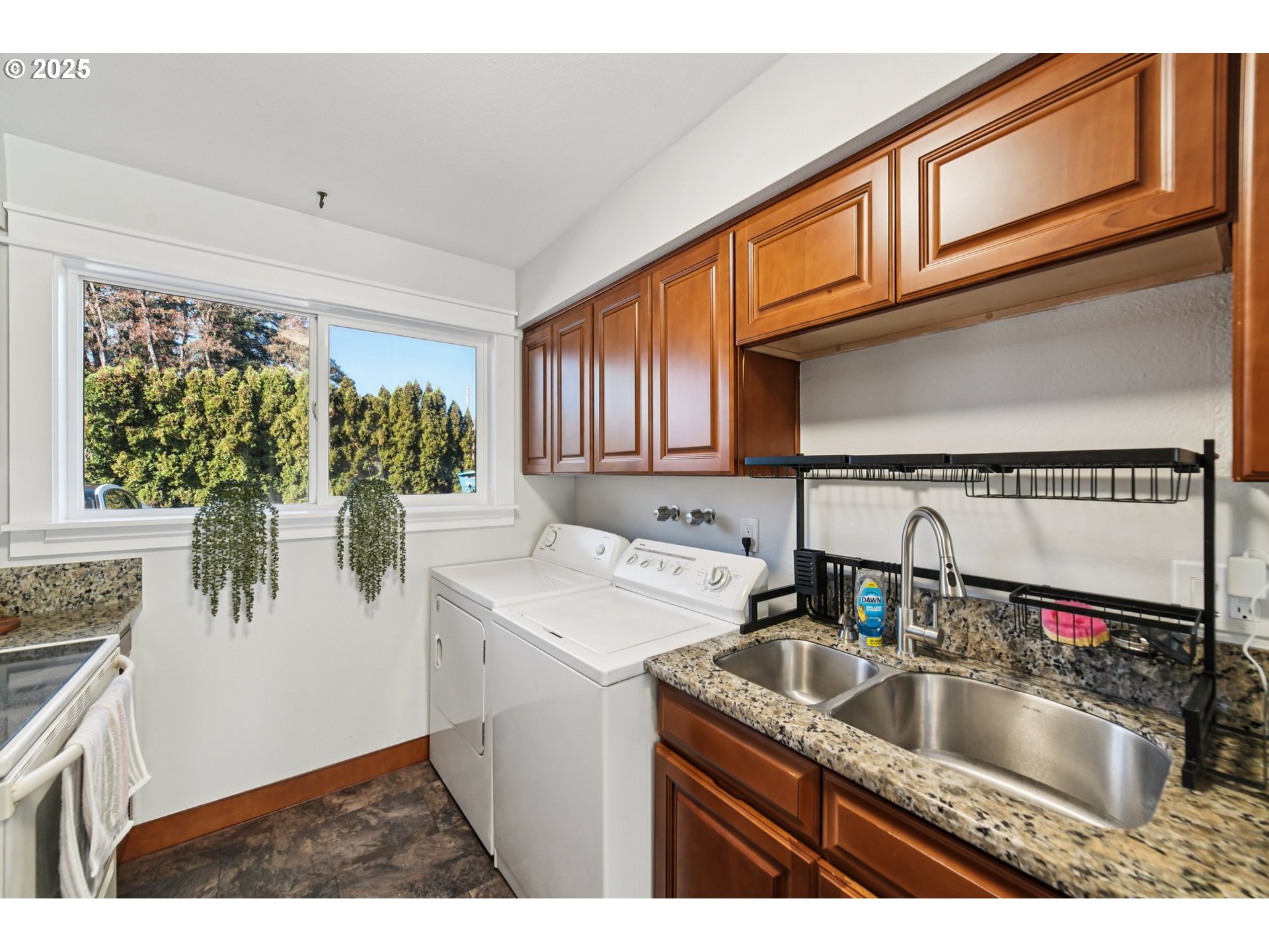 1302 Northeast Hogan Drive, Unit 169 Gresham, OR 97030 - Photo 15 of 46 a kitchen with a sink cabinets and a wooden floor