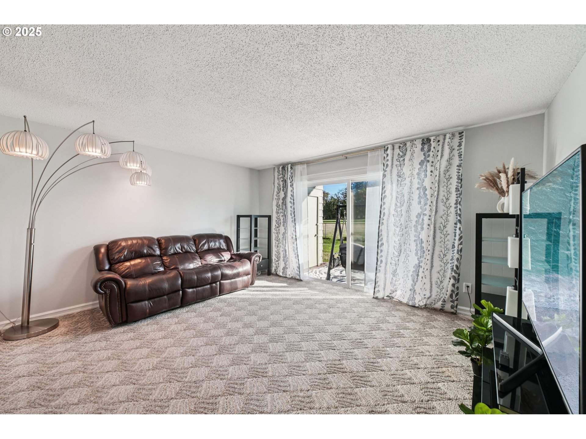 1302 Northeast Hogan Drive, Unit 169 Gresham, OR 97030 - Photo 18 of 46 a bedroom with a bed window and a couch