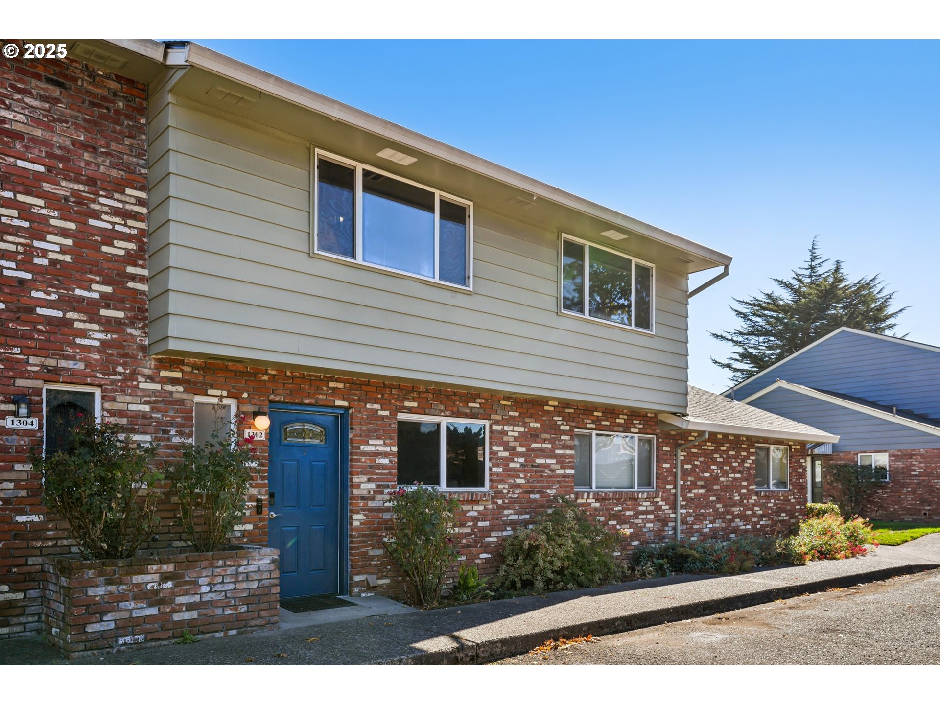 1302 Northeast Hogan Drive, Unit 169 Gresham, OR 97030 - Photo 2 of 46 a front view of a house with garden
