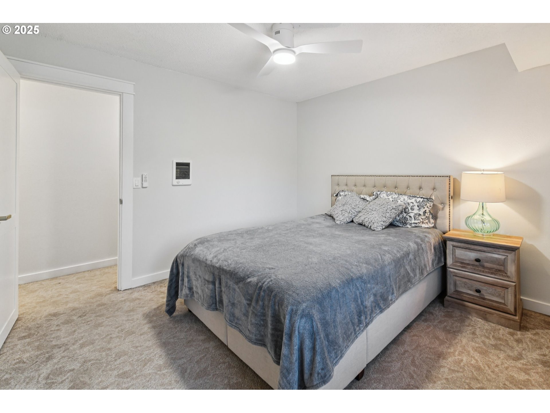 1302 Northeast Hogan Drive, Unit 169 Gresham, OR 97030 - Photo 22 of 46 a bedroom with a bed and a night stand