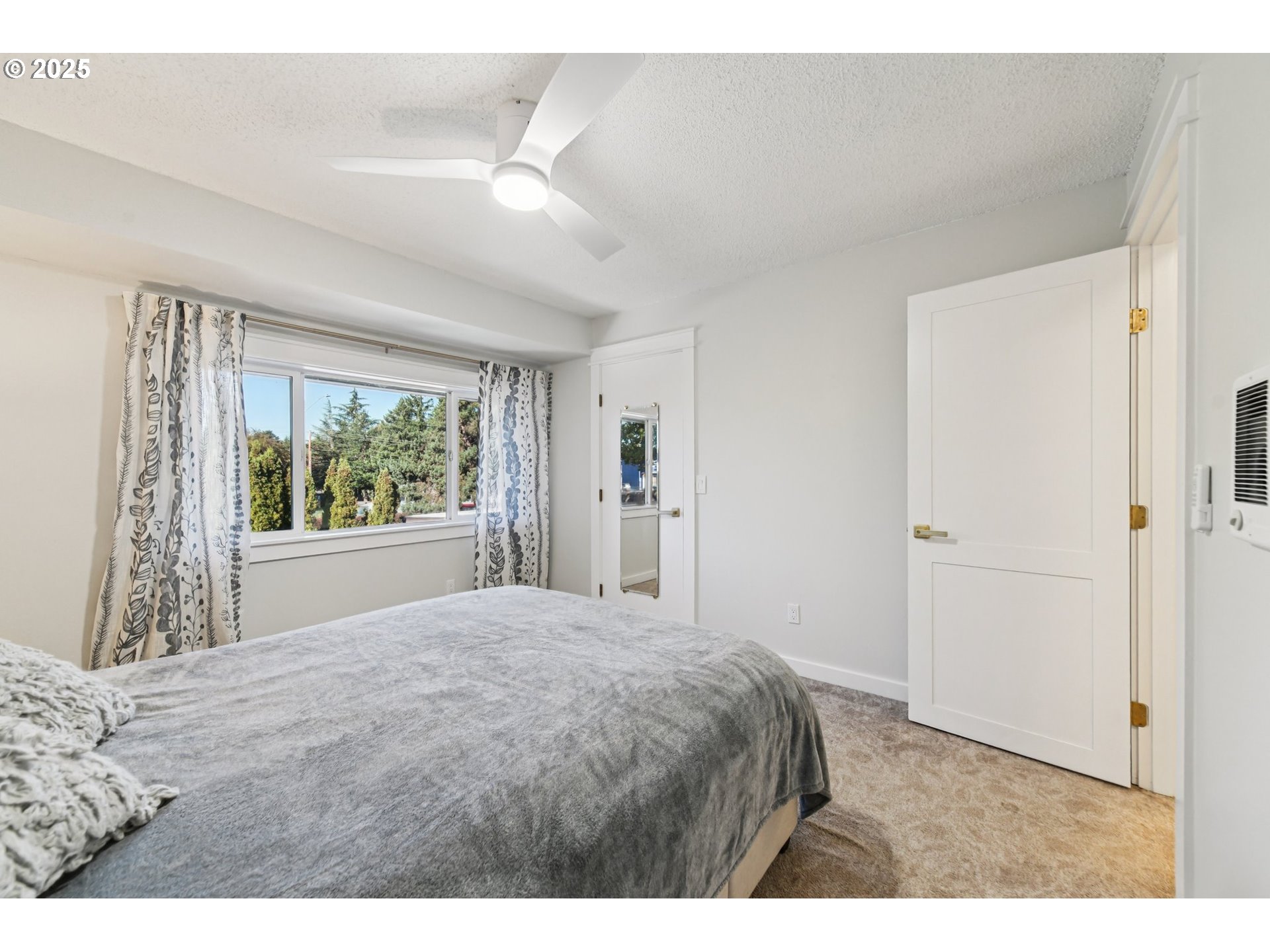 1302 Northeast Hogan Drive, Unit 169 Gresham, OR 97030 - Photo 23 of 46 a bedroom with a large bed and a window