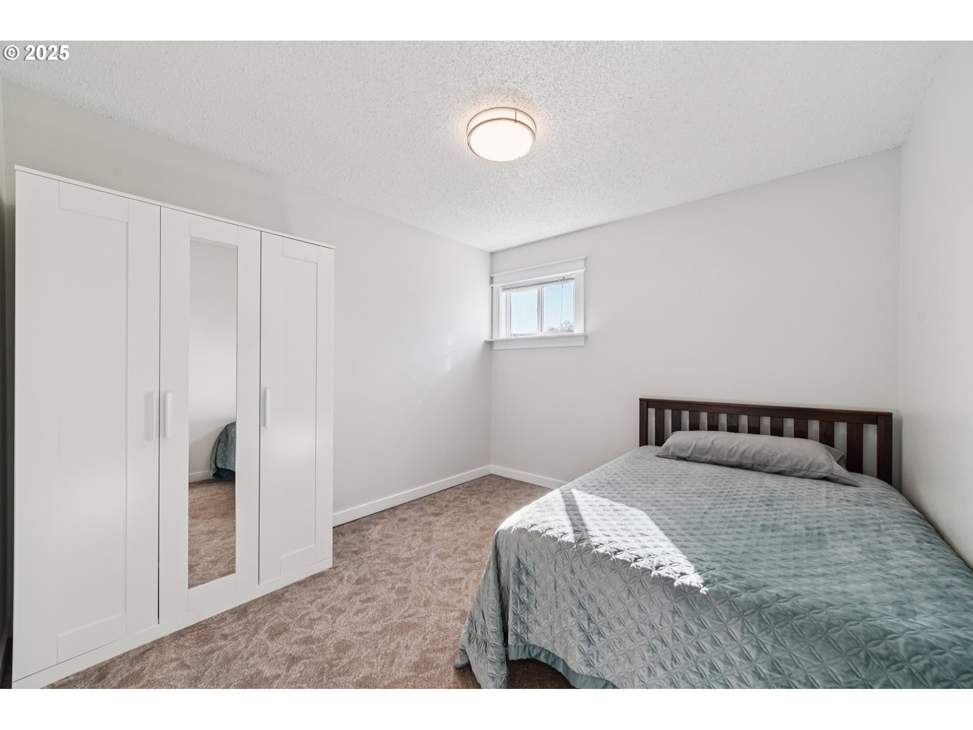 1302 Northeast Hogan Drive, Unit 169 Gresham, OR 97030 - Photo 27 of 46 a bedroom with a bed and a window