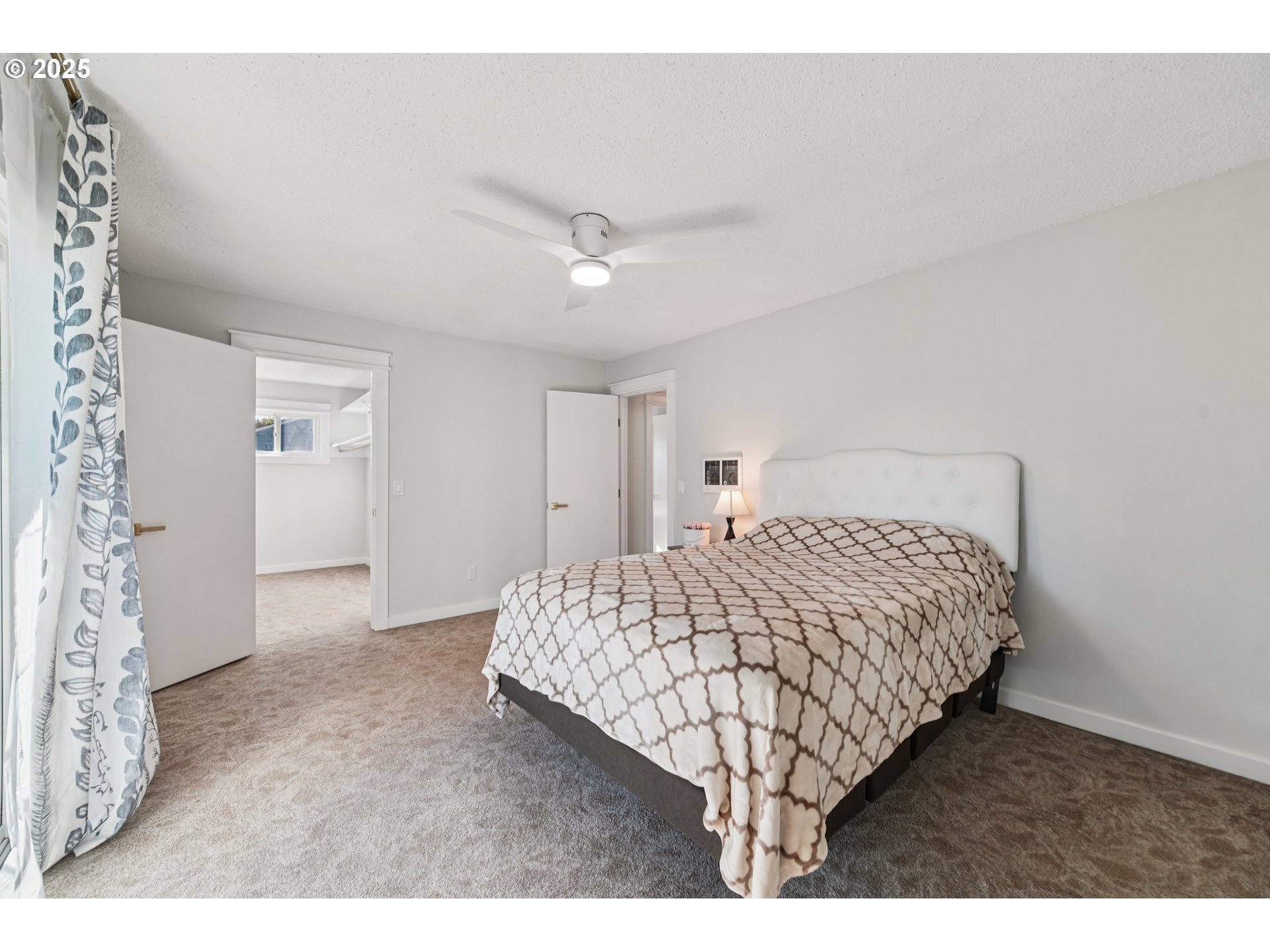 1302 Northeast Hogan Drive, Unit 169 Gresham, OR 97030 - Photo 30 of 46 a bedroom with a bed and a night stand