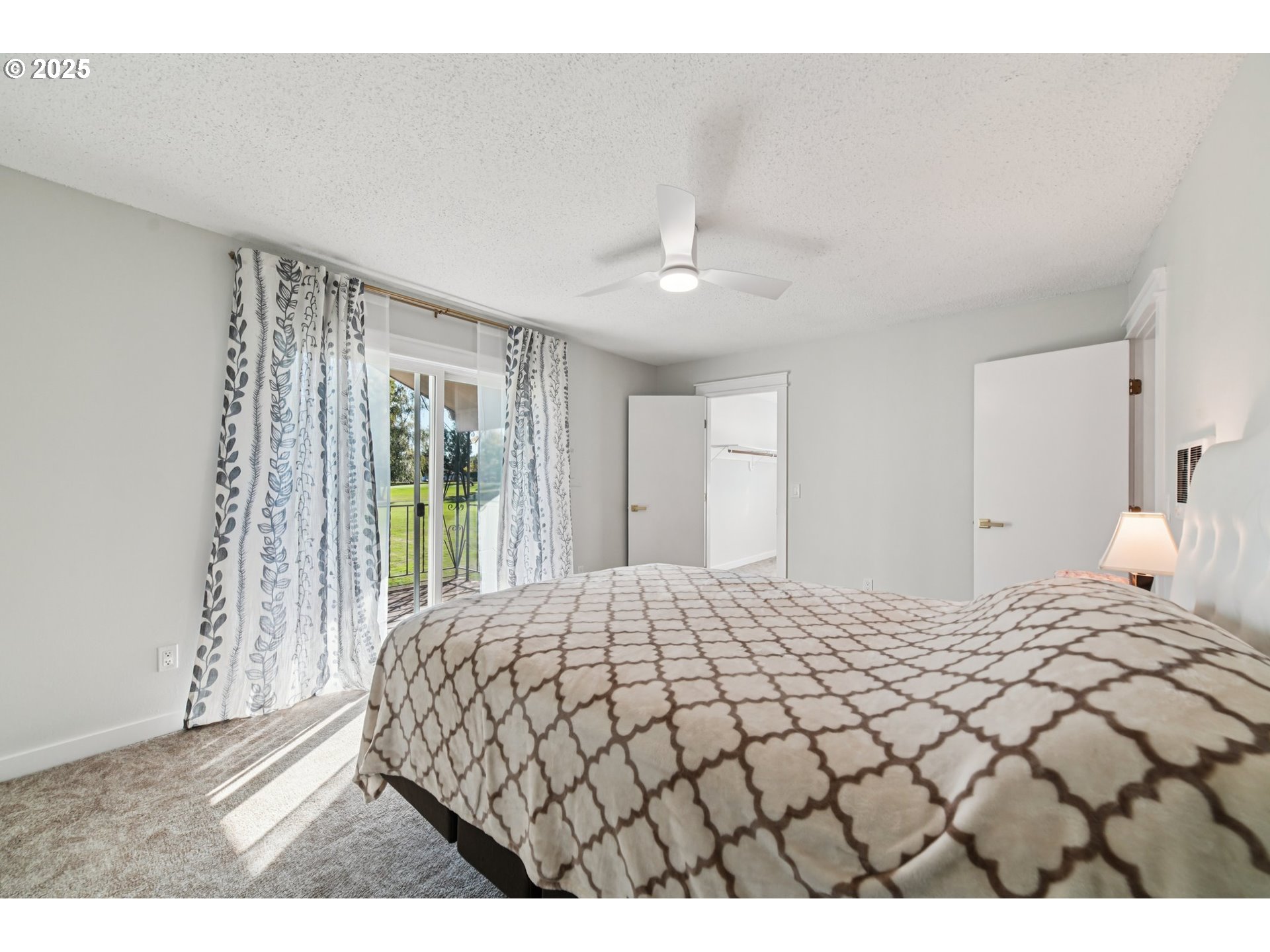 1302 Northeast Hogan Drive, Unit 169 Gresham, OR 97030 - Photo 31 of 46 a bedroom with a large bed and a chandelier