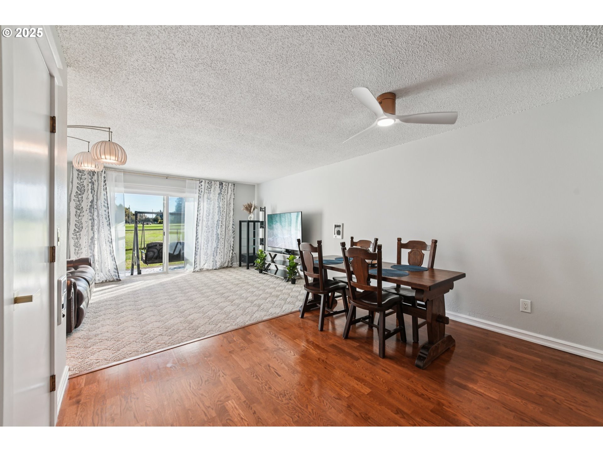 1302 Northeast Hogan Drive, Unit 169 Gresham, OR 97030 - Photo 7 of 46 a view of a dining room with furniture and chandelier