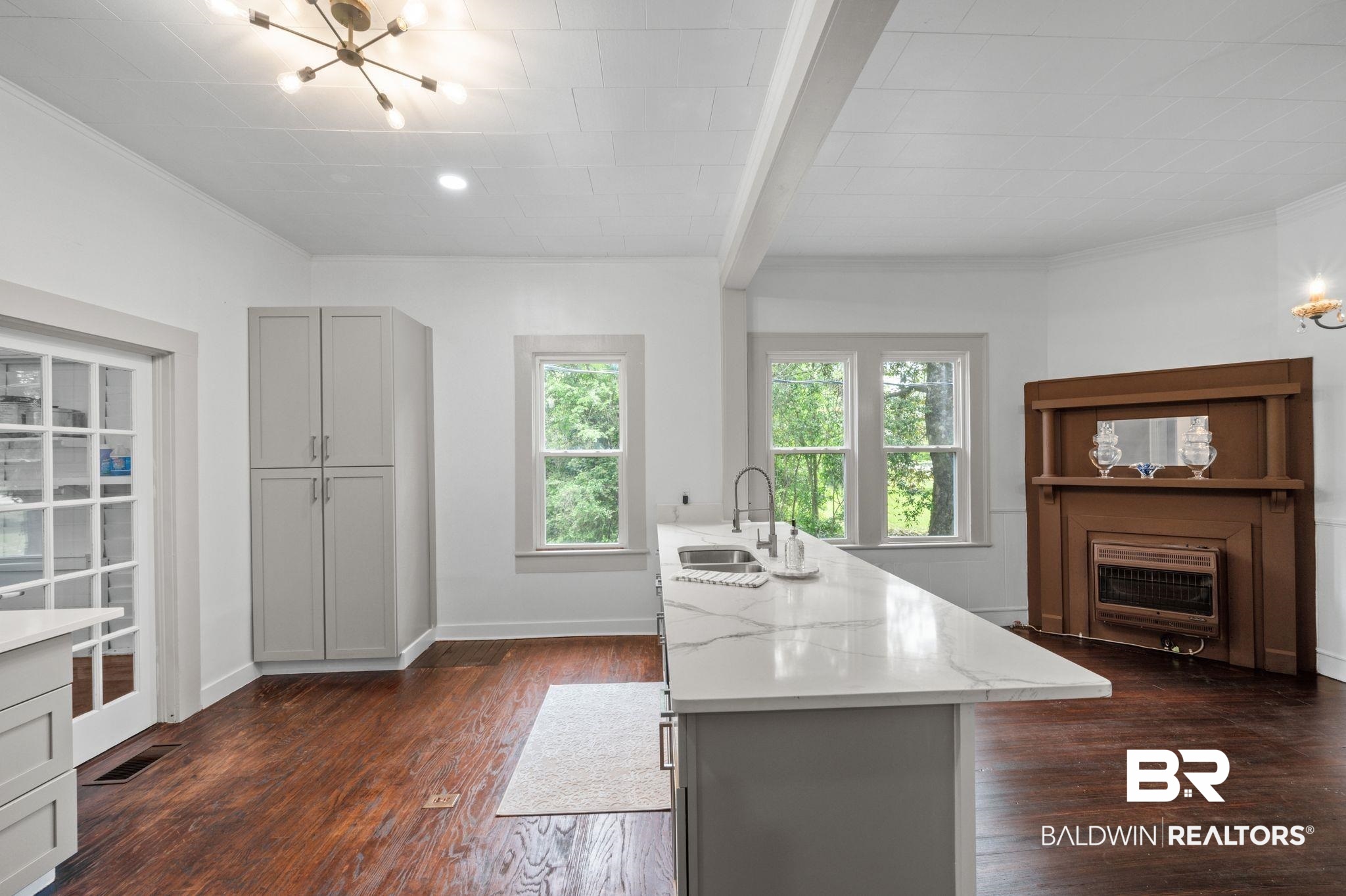 733 Pineville Road Monroeville, AL 36460 - Photo 16 of 68 Kitchen featuring a sink, light stone countertops, dark wood finished floors, and a notable chandelier