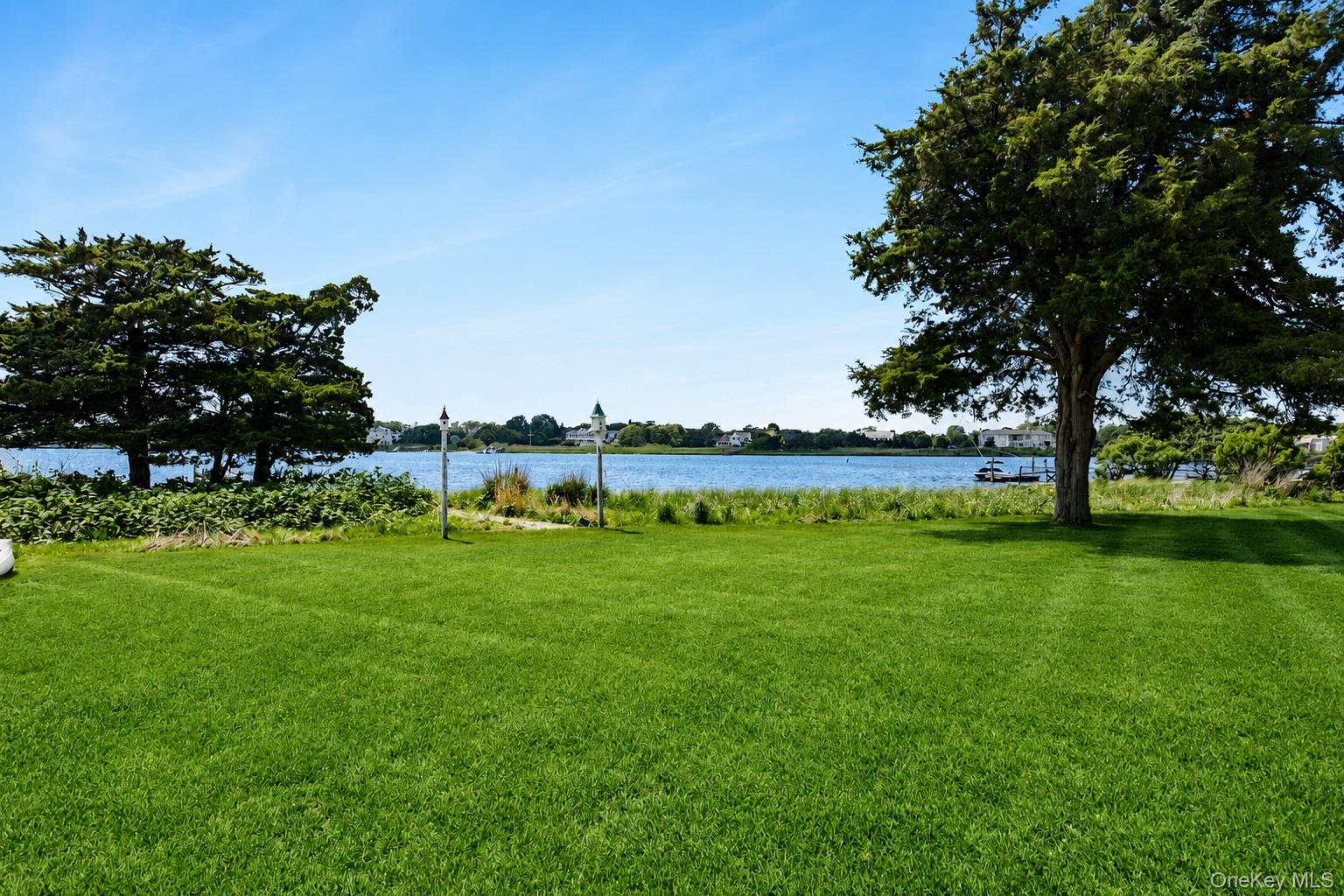 65 Shore Road Westhampton, NY 11977 - Photo 5 of 24 Expansive lawn with mature trees and waterfront access