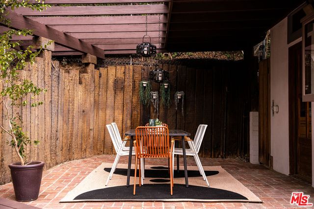 a patio with a table and chairs