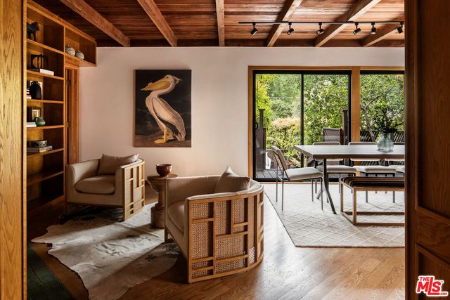 a living room with furniture and a floor to ceiling window