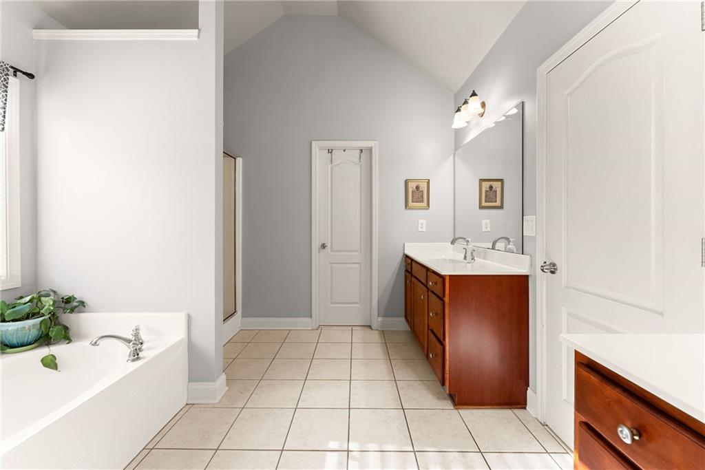 725 Larry Lane Winder, GA 30680 - Photo 30 of 62 a spacious bathroom with a tub sink and mirror