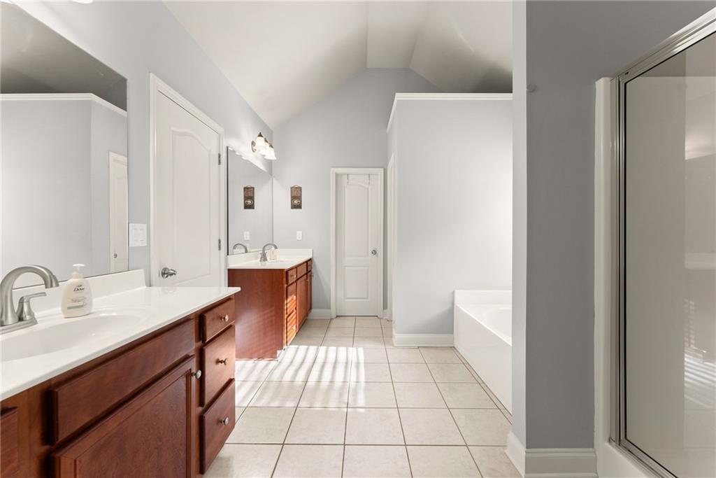 725 Larry Lane Winder, GA 30680 - Photo 33 of 62 a spacious bathroom with a double vanity sink mirror and toilet