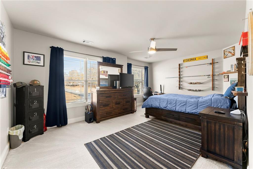 725 Larry Lane Winder, GA 30680 - Photo 35 of 62 a bedroom with a bed and wooden floor