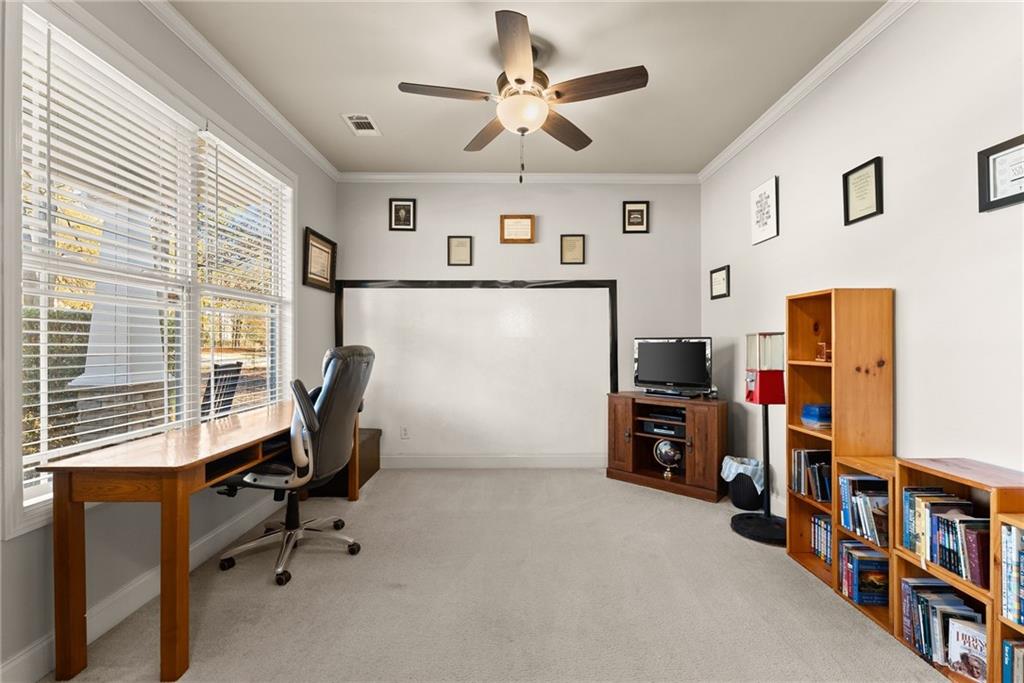 725 Larry Lane Winder, GA 30680 - Photo 8 of 62 a view of a workspace with furniture and a window