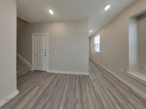 a view of an empty room and wooden floor