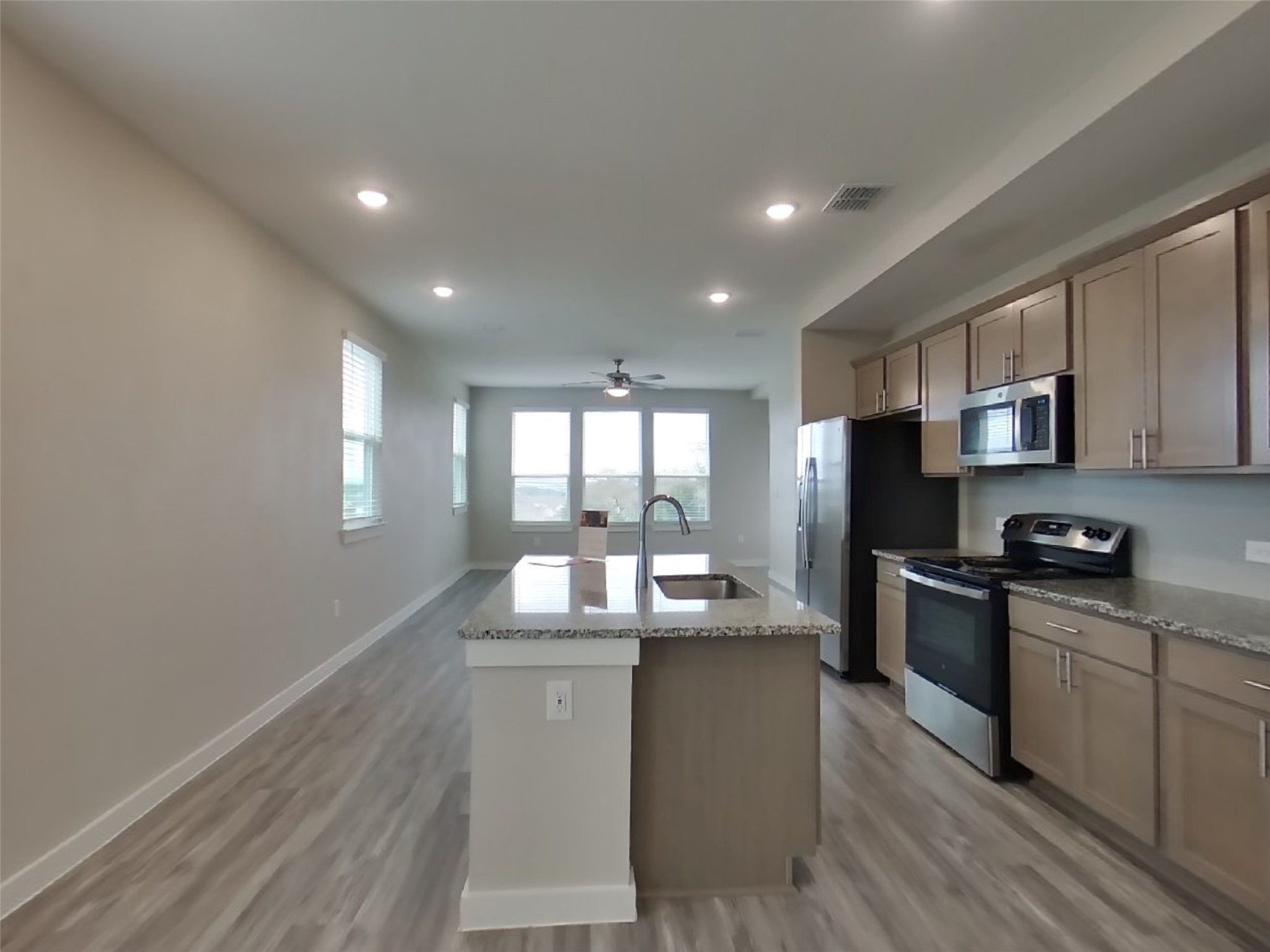 509 Raglands Road Leander, TX 78641 - Photo 4 of 18 a kitchen with stainless steel appliances granite countertop a sink stove and refrigerator