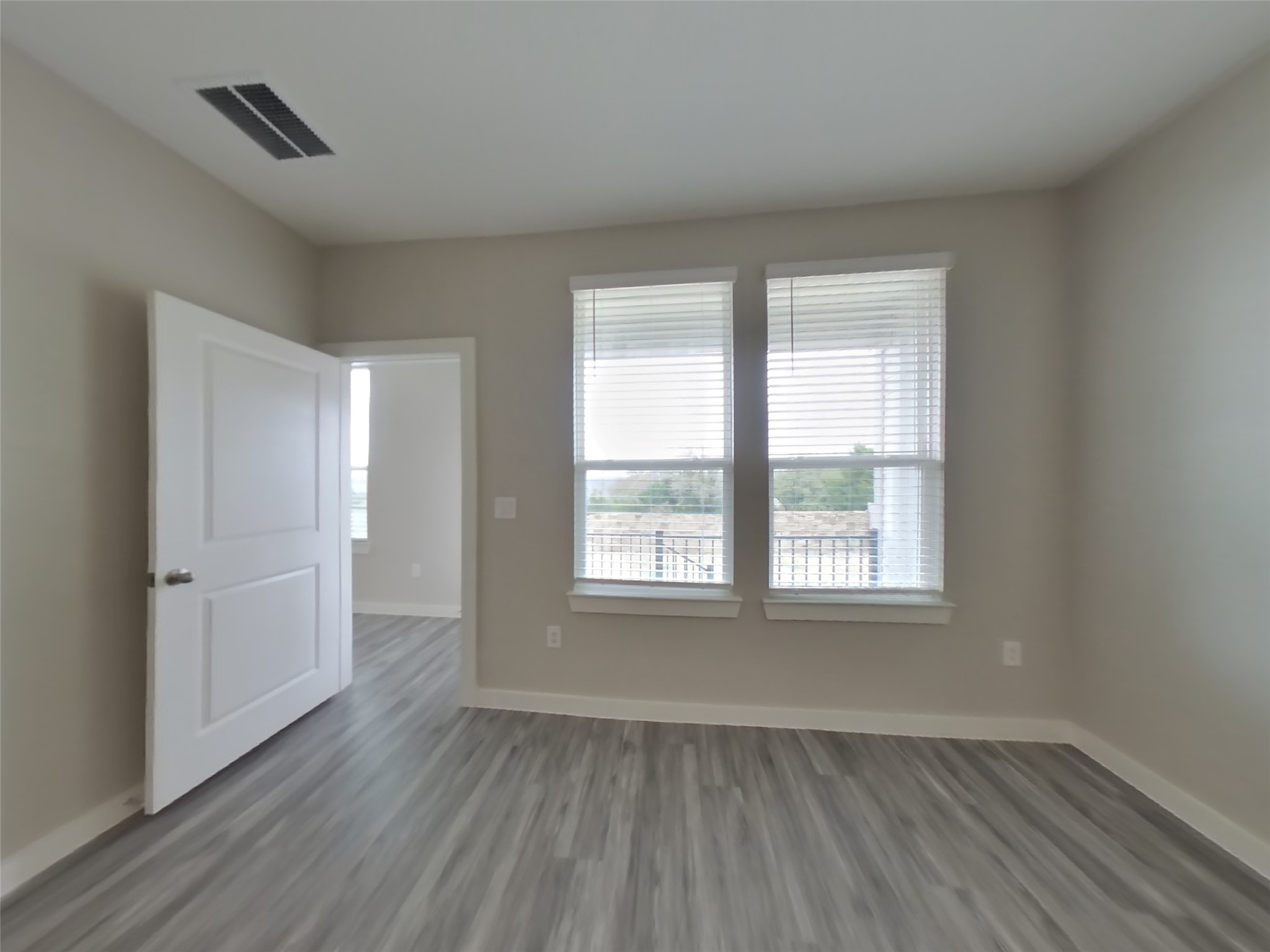 509 Raglands Road Leander, TX 78641 - Photo 6 of 18 an empty room with wooden floor and windows