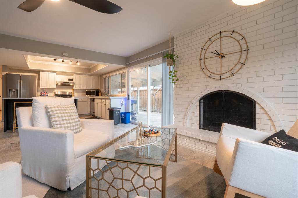 3124 Barton Road Carrollton, TX 75007 - Photo 16 of 36 a living room with furniture a fireplace and a flat screen tv