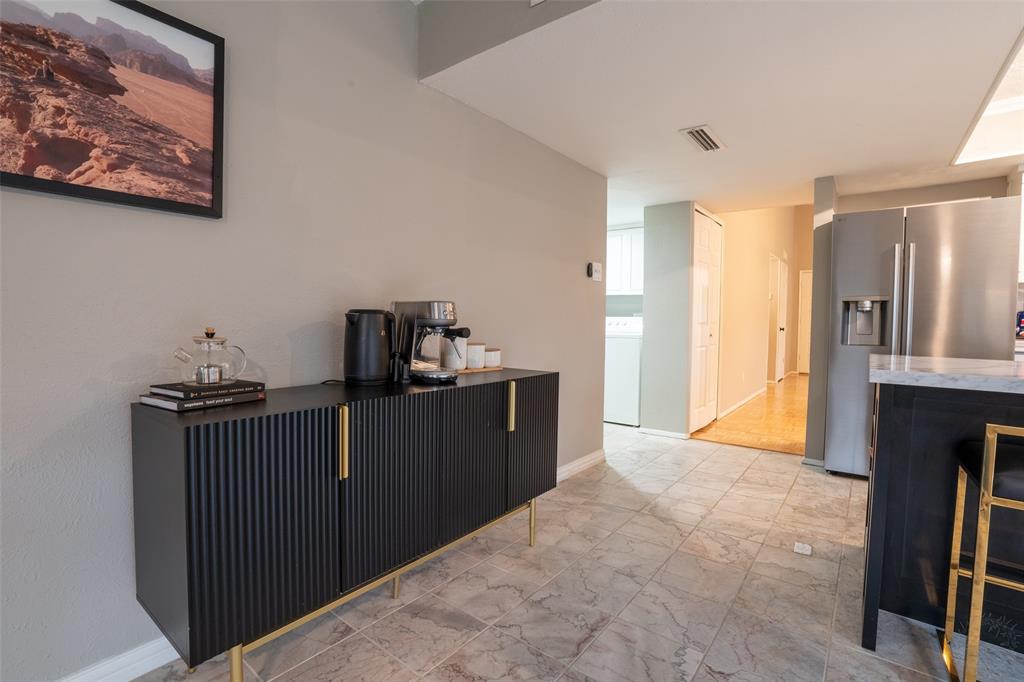 3124 Barton Road Carrollton, TX 75007 - Photo 19 of 36 a kitchen with a refrigerator and a stove top oven
