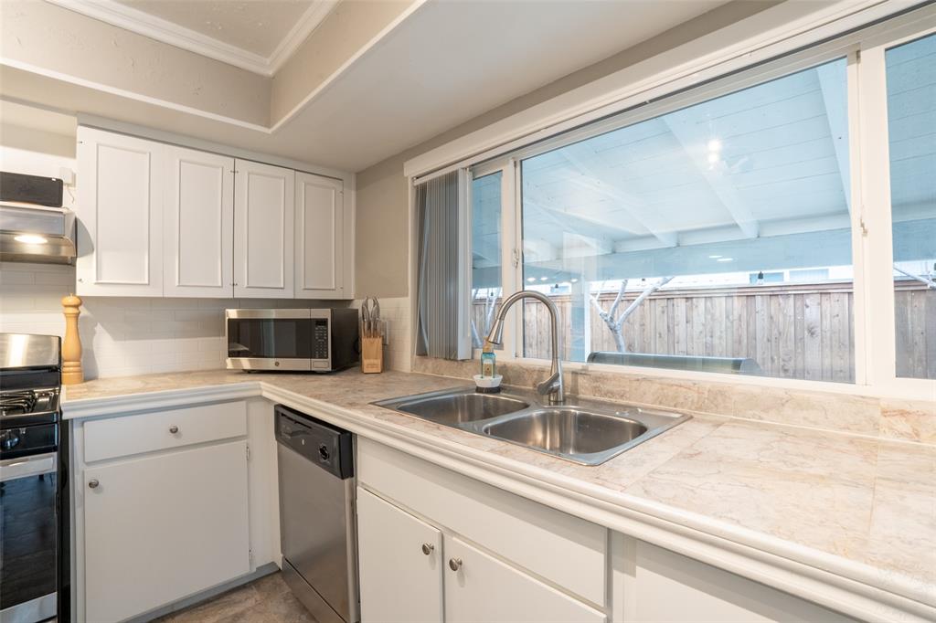 3124 Barton Road Carrollton, TX 75007 - Photo 24 of 36 a kitchen with a sink and cabinets