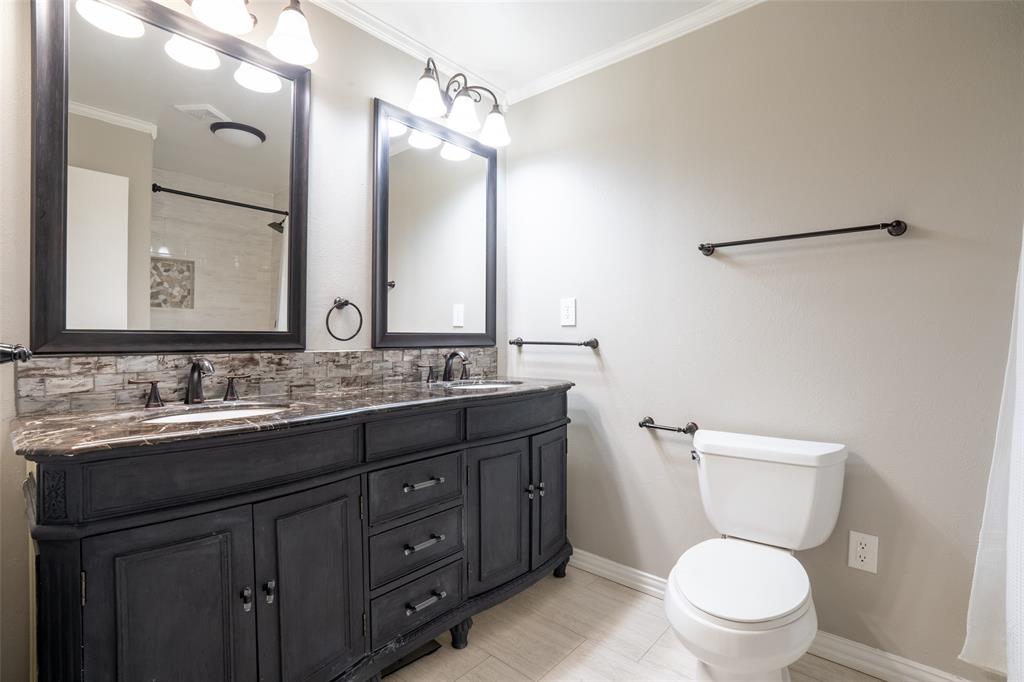 3124 Barton Road Carrollton, TX 75007 - Photo 29 of 36 a bathroom with a granite countertop toilet sink and a mirror