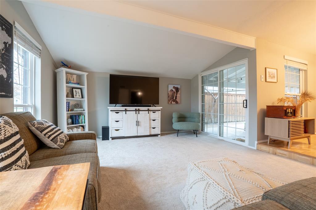 3124 Barton Road Carrollton, TX 75007 - Photo 8 of 36 a view of a livingroom with furniture flat screen tv and floor to ceiling window