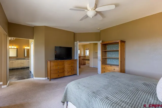 a bedroom with a bed and a television