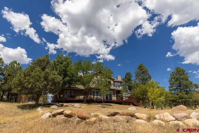 a view of a house with a yard covered in snow